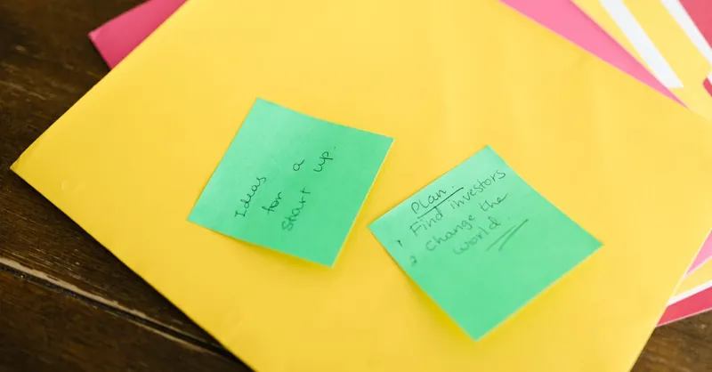 Vibrant sticky notes with startup ideas and plans placed on a desk.