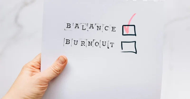 A hand holding a checklist highlighting the choice of balance over burnout, emphasizing mental health awareness.