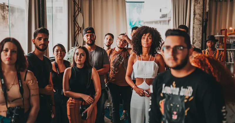 Vibrant and diverse group gathering at an indoor event in São Paulo, fostering interaction and collaboration.