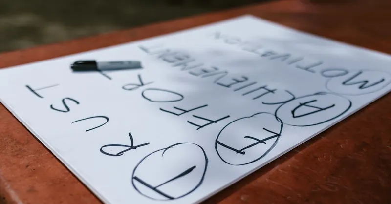 A paper with motivational words and markings placed outdoors on a table.