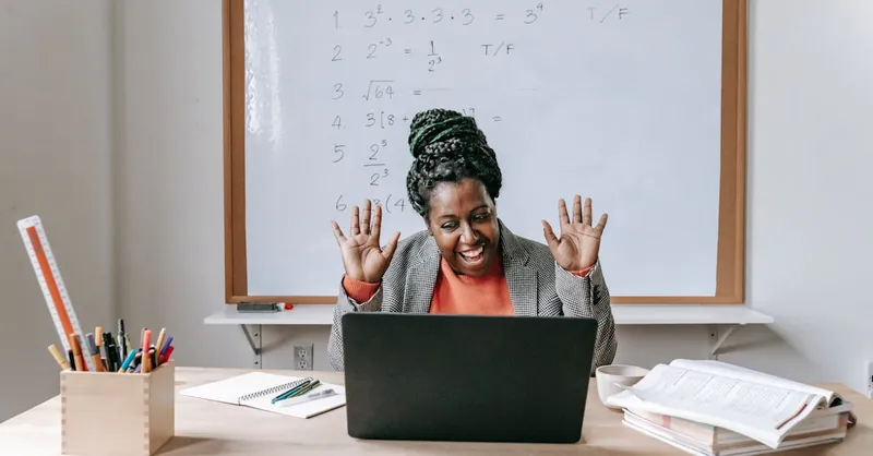 Smiling teacher enjoying an online math class with equations on whiteboard.